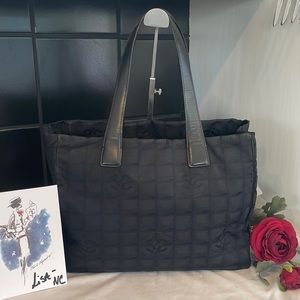Chanel black purse / tote with Chanel scarf.